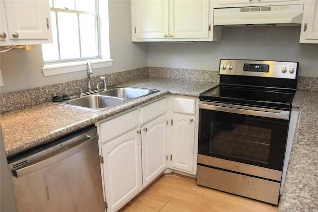 kitchen featuring white cabinets, light hardwood / wood-style floors, appliances with stainless steel finishes, and sink