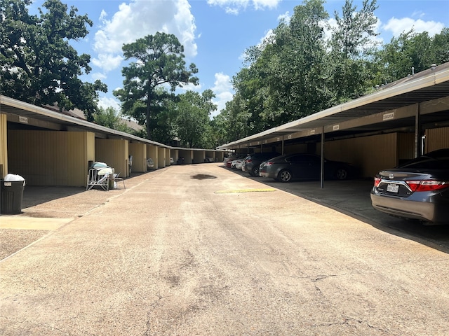 view of parking / parking lot featuring a carport