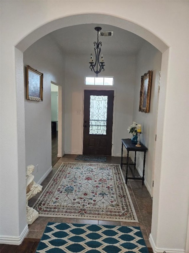 10438 Lauren Creek Dr, Baytown, TX 77523 - entryway with arched walkways, a chandelier, and baseboards