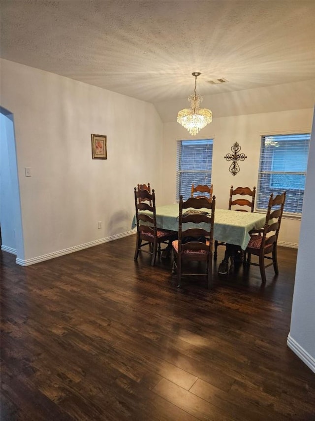 10438 Lauren Creek Dr, Baytown, TX 77523 - dining space with a chandelier, dark wood-style flooring, baseboards, and vaulted ceiling