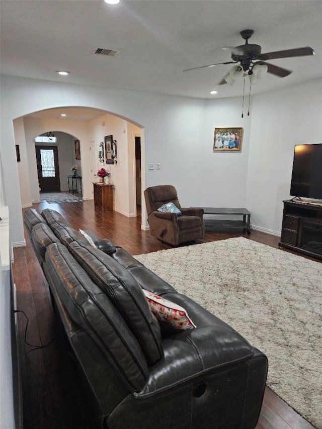 10438 Lauren Creek Dr, Baytown, TX 77523 - living room with arched walkways, a ceiling fan, recessed lighting, wood finished floors, and baseboards