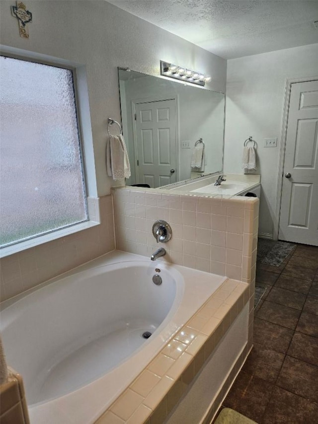 10438 Lauren Creek Dr, Baytown, TX 77523 - bathroom featuring a garden tub and a textured ceiling