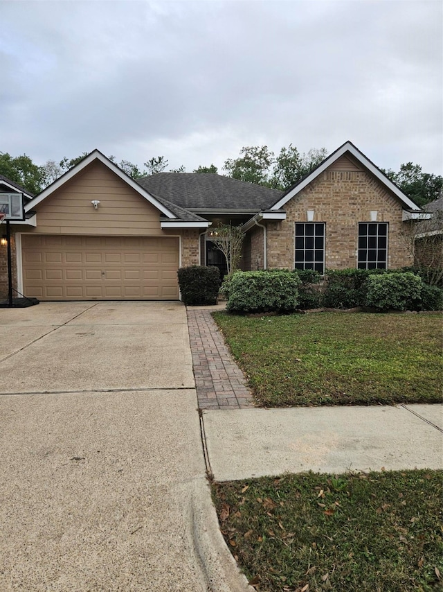 ranch-style house with a garage and a front lawn