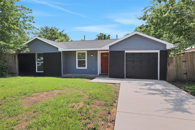 ranch-style house featuring a garage and a front yard