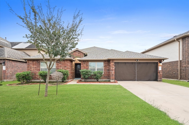 view of front of home featuring a garage and a front yard