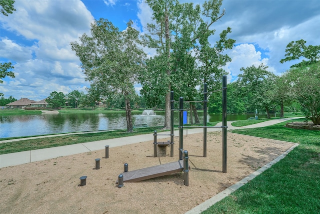 view of community with a yard and a water view