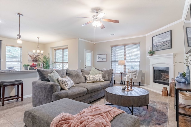 tiled living room with ornamental molding and ceiling fan with notable chandelier