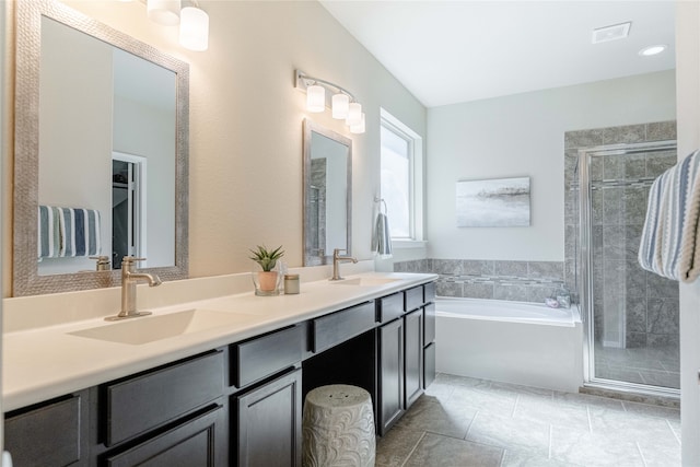 bathroom with independent shower and bath, vanity, and tile patterned floors