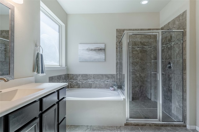 bathroom featuring independent shower and bath, tile patterned flooring, and vanity