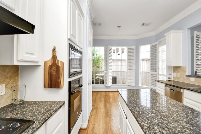 kitchen with decorative backsplash, light hardwood / wood-style floors, white cabinetry, and black appliances