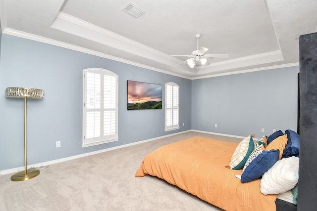 bedroom featuring carpet, ceiling fan, a raised ceiling, and crown molding