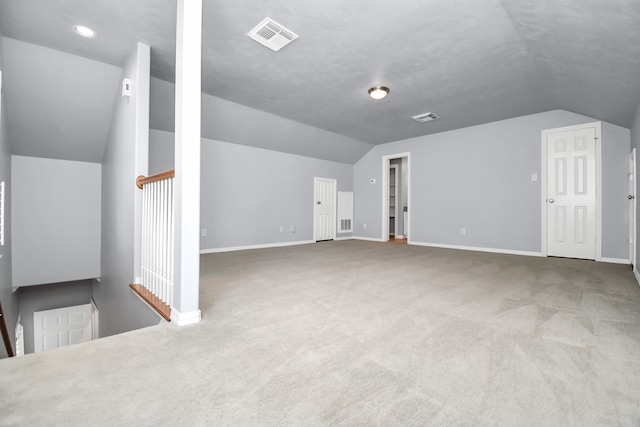 additional living space featuring carpet and lofted ceiling