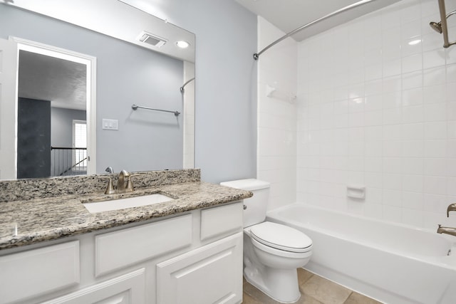 full bathroom featuring tile patterned floors, vanity, toilet, and tiled shower / bath combo