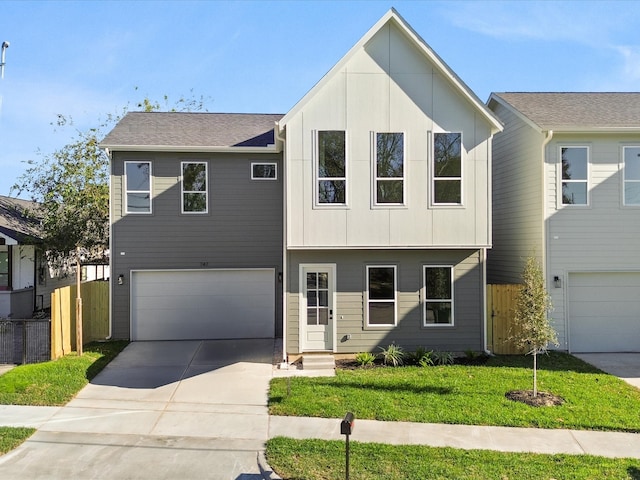 view of front of property with a garage and a front yard