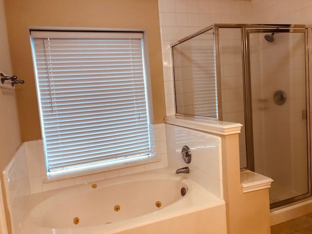 bathroom with independent shower and bath and plenty of natural light