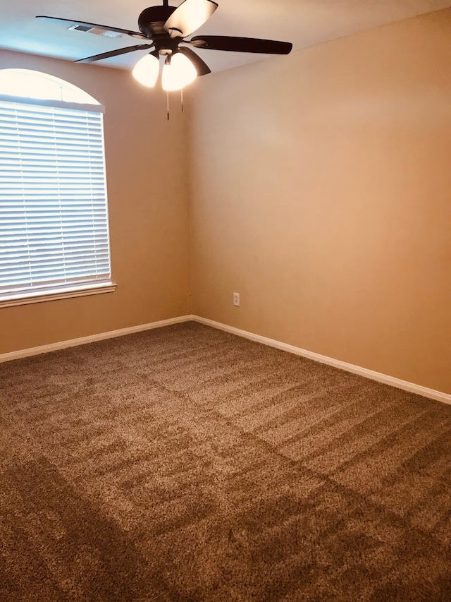 empty room featuring carpet floors and ceiling fan