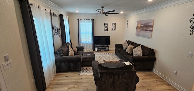 living room featuring light hardwood / wood-style floors, ceiling fan, and ornamental molding