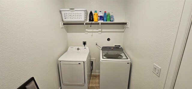 18103 Shaman Dr, Galveston, TX 77554 - laundry area with washer and dryer and a textured wall