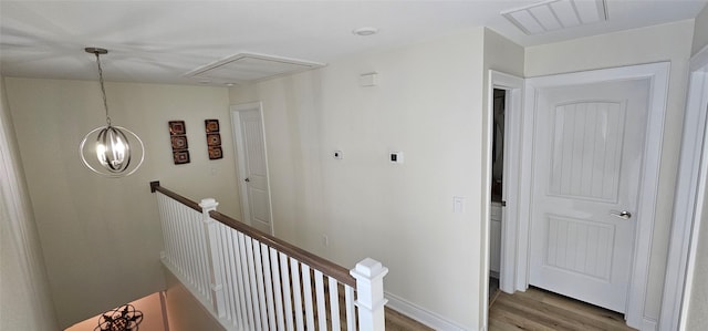 18103 Shaman Dr, Galveston, TX 77554 - hall with an upstairs landing, wood finished floors, and attic access