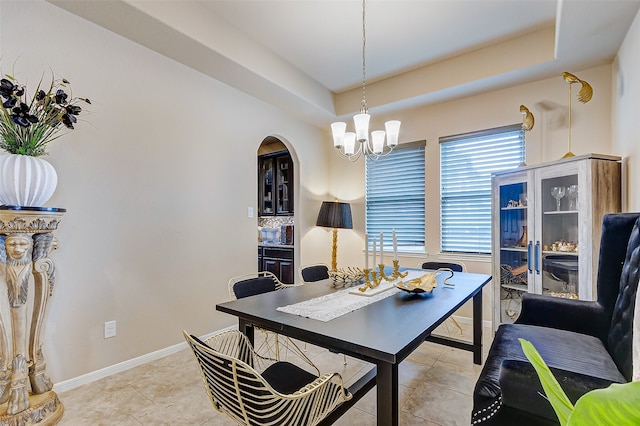 tiled office with an inviting chandelier and a raised ceiling