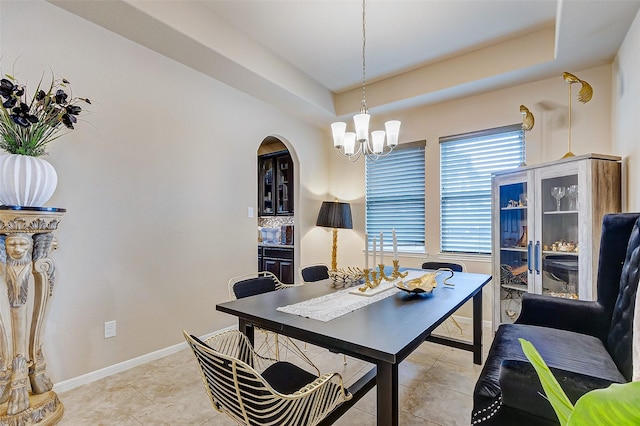 3614 Daintree Park Dr, Katy, TX 77494 - home office featuring a chandelier, a tray ceiling, arched walkways, and baseboards