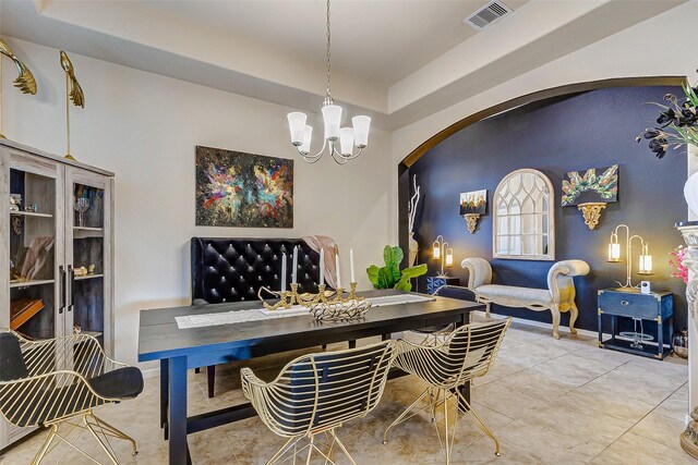 3614 Daintree Park Dr, Katy, TX 77494 - dining space with arched walkways, a chandelier, a tray ceiling, and light tile patterned flooring