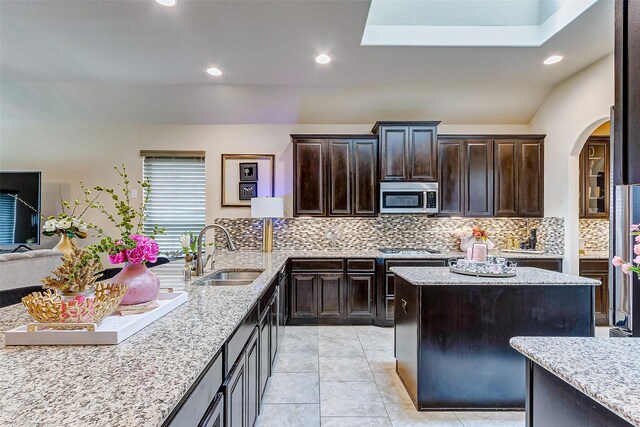 3614 Daintree Park Dr, Katy, TX 77494 - kitchen featuring a sink, stainless steel appliances, arched walkways, tasteful backsplash, and recessed lighting