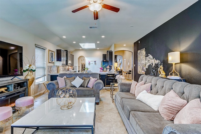 tiled living room with ceiling fan