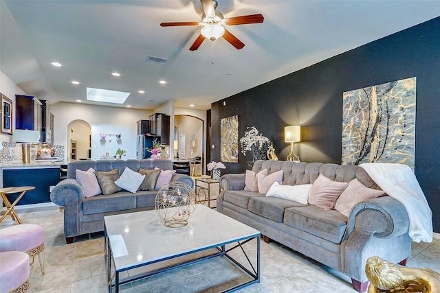3614 Daintree Park Dr, Katy, TX 77494 - living room featuring arched walkways, a ceiling fan, recessed lighting, light tile patterned floors, and a skylight