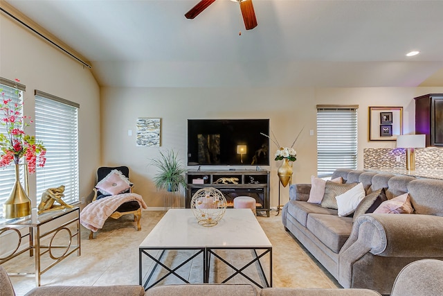 living room featuring light tile patterned flooring, lofted ceiling, and ceiling fan