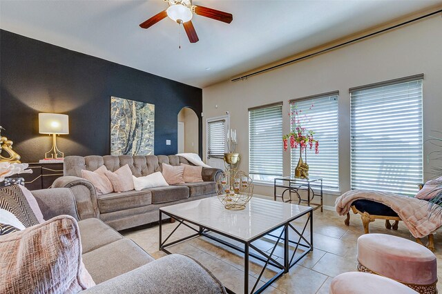 3614 Daintree Park Dr, Katy, TX 77494 - living area featuring ceiling fan, arched walkways, light tile patterned floors, and an accent wall