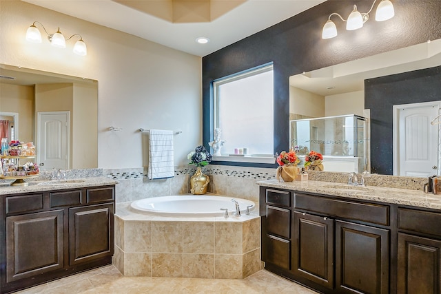 bathroom with independent shower and bath, vanity, and tile patterned flooring