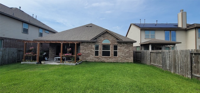 rear view of property with a patio and a lawn