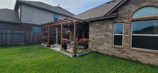 back of house with a yard, a pergola, and a patio area