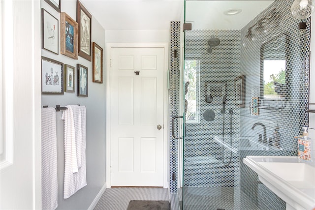 bathroom with tile patterned floors, sink, and walk in shower