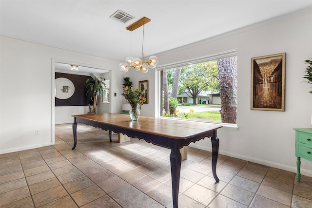 dining area with an inviting chandelier and crown molding