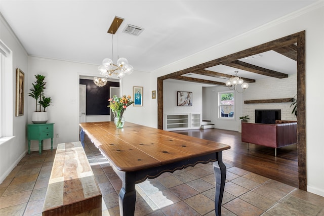 dining area with hardwood / wood-style flooring, a notable chandelier, beam ceiling, and crown molding