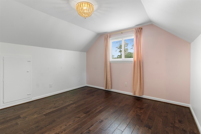 additional living space featuring dark hardwood / wood-style flooring and vaulted ceiling