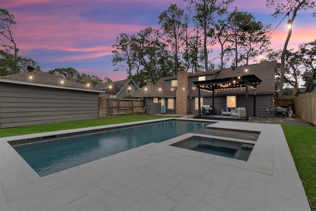 pool at dusk featuring a pergola, a patio area, and an in ground hot tub