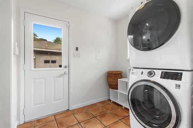 laundry area featuring light tile patterned floors and stacked washer and dryer