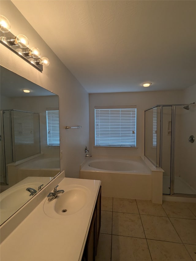 bathroom featuring tile patterned flooring, shower with separate bathtub, and vanity