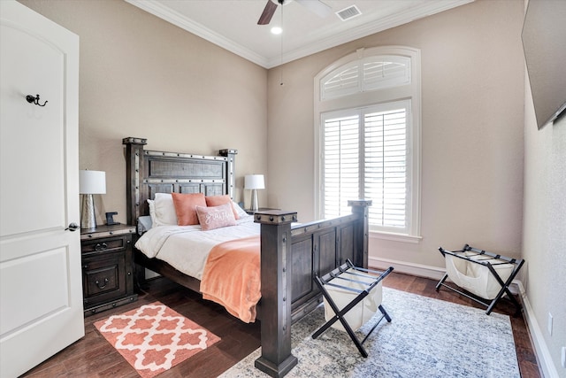 bedroom with dark wood-type flooring, ceiling fan, and crown molding