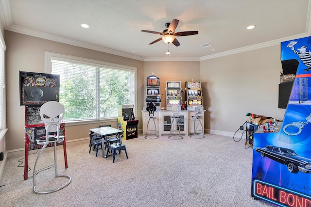 recreation room featuring ornamental molding, carpet flooring, and ceiling fan