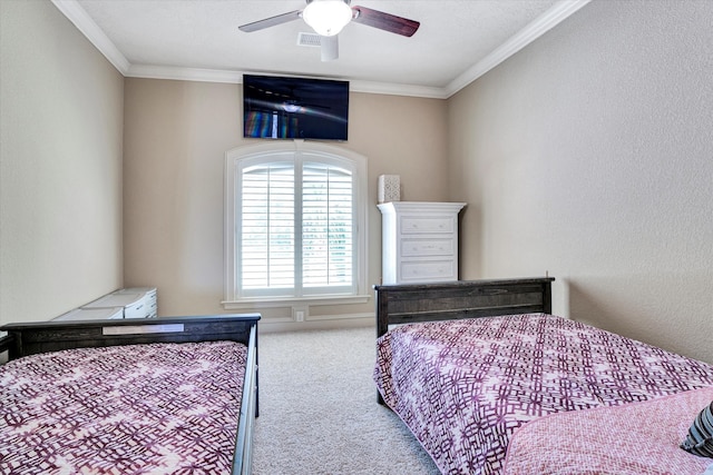 carpeted bedroom featuring ceiling fan and crown molding