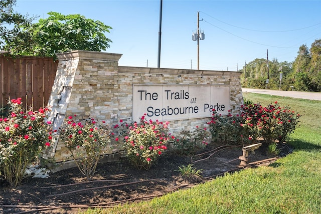 community / neighborhood sign with fence