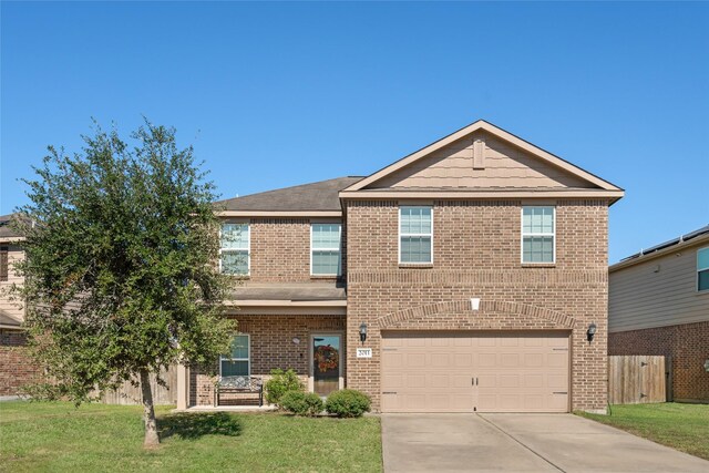 view of front of property with a garage and a front yard