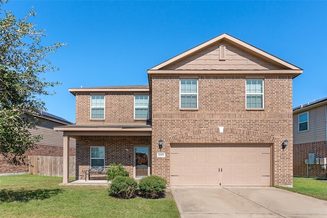 traditional home featuring brick siding, fence, a garage, driveway, and a front lawn