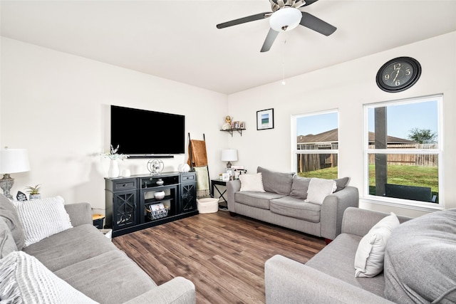 living room with ceiling fan and dark wood finished floors