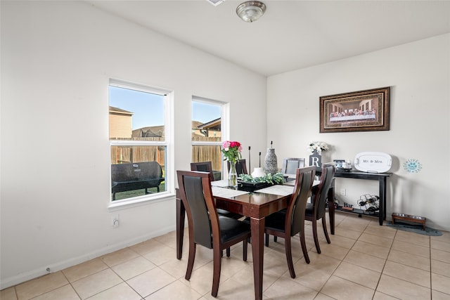 dining room with baseboards and light tile patterned floors