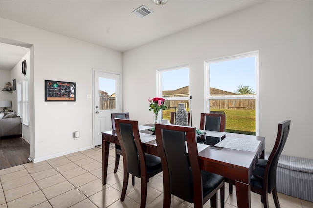 dining space featuring light tile patterned floors, baseboards, and visible vents